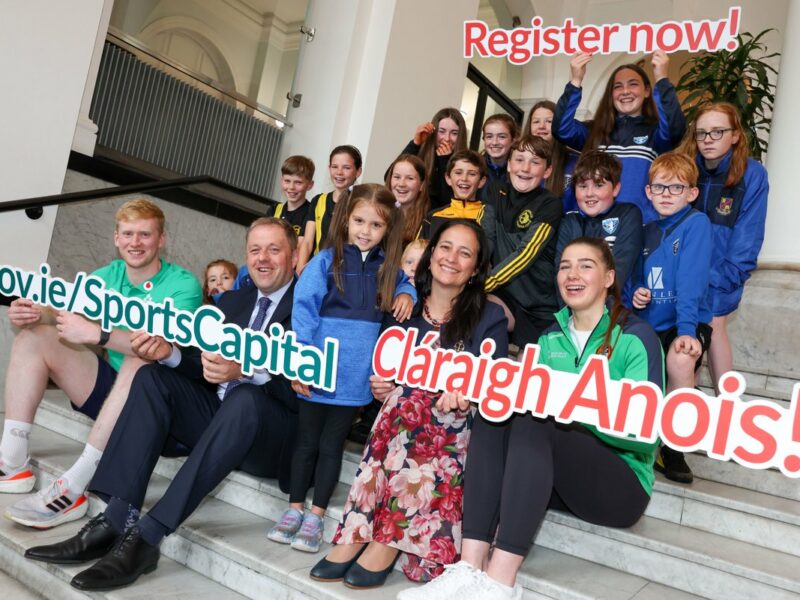 Minister for Sport with Children sitting on steps