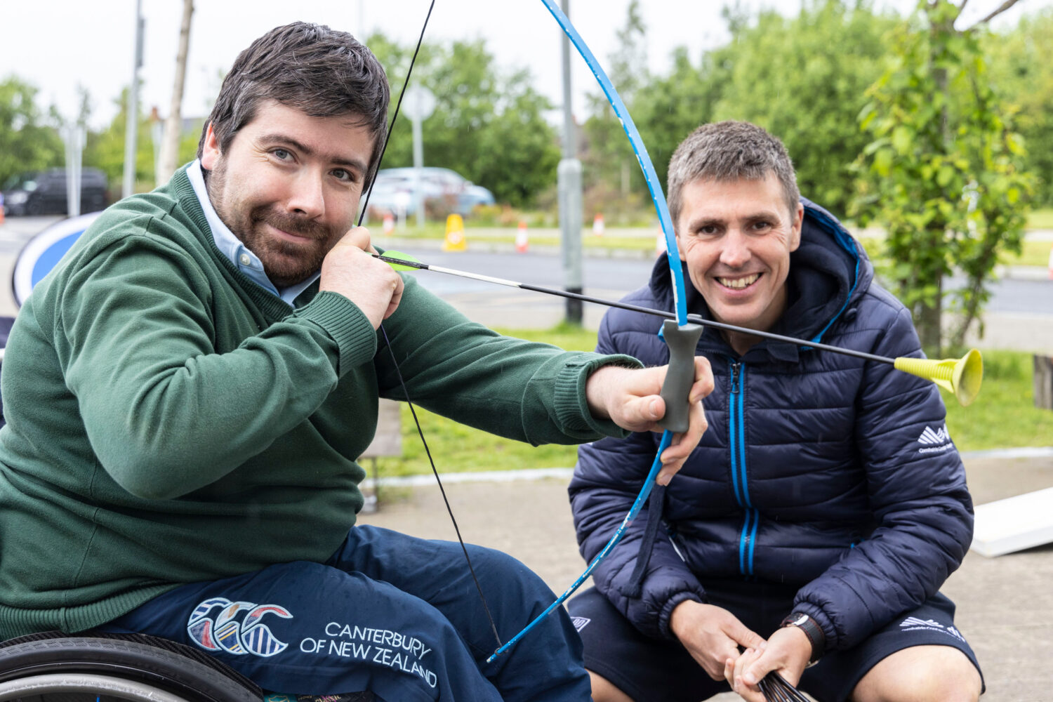 Man holding bow and arrow outstretched